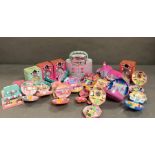 An extensive selection of Polly Pocket toys to include clocks and make up case