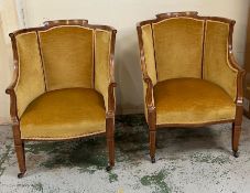 A pair of easy salon chairs inlaid, scrolling arms and tapering legs