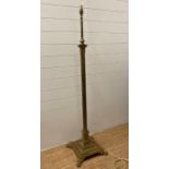 A brass Corinthian column floor standing lamp on a square base with lion paw feet