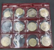 A selection of coins to include: A Marie Theresa, Russian Rouble, 1927 USA silver dollar etc.