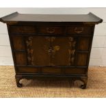 A Korean style cabinet with small drawers, running across the top and a cabinet below