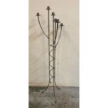 A six arm wrought iron floor standing candle holder
