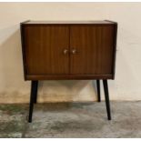 A Mid Century two door record cabinet on splayed legs