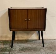 A Mid Century two door record cabinet on splayed legs