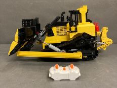 A Lego Technics radio controlled model of a bulldozer
