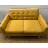 A Mid Century style mustard upholstered two seater button back sofa