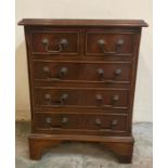 A small mahogany chest of drawers with two short over three graduated drawers and drop handles (