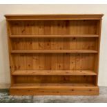 A pine four shelf bookcase (H108cm W120cm D23cm)