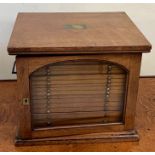 A Victorian mahogany microscope slide cabinet with brass handles and glazed door opening to eighteen