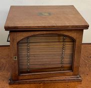 A Victorian mahogany microscope slide cabinet with brass handles and glazed door opening to eighteen