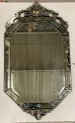 A late 19th century venetian etched glass wall mirror, pierced cresting above bevelled octagonal
