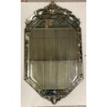 A late 19th century venetian etched glass wall mirror, pierced cresting above bevelled octagonal