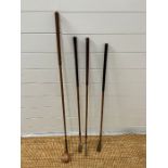 Four wooden vintage golf clubs