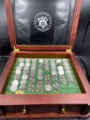 Wooden display chest of uncirculated USA quarters, top layer 54 single coins, storage drawers