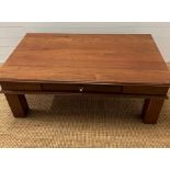 A hardwood coffee table with drawer to centre (H48cm W130cm D74cm)