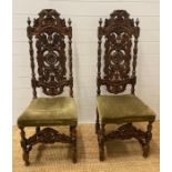 A pair of oak Victorian carved hall chairs circa 1880