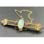 An Opal and ruby brooch in a gold setting AF