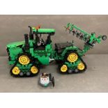 A Lego Technic radio controlled tractor with plough