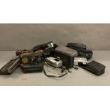 A quantity of vintage camera equipment to include Polaroid, Hanimex and Carrion