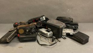 A quantity of vintage camera equipment to include Polaroid, Hanimex and Carrion