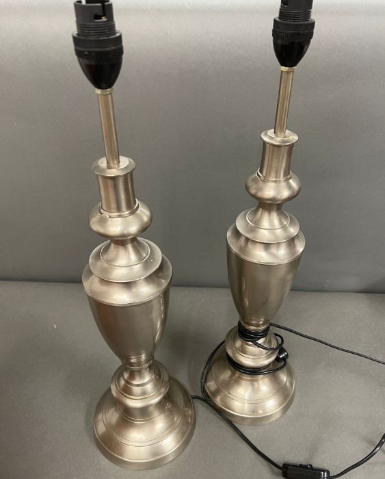 A pair of brush steel trophy shape table lamps