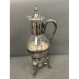 A plated claret jug on stand