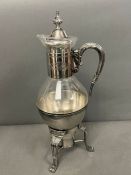 A plated claret jug on stand