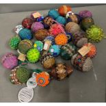 A collection of vivid beaded eggs and balls