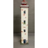 A wooden storage cupboard in the form of a light house (H106cm Sq18cm)
