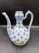 A porcelain ewer painted in cobalt blue underglaze