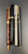 A small selection of four pens including a Parker Fountain pen