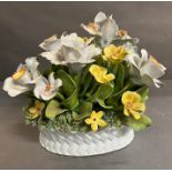 A porcelain flower arrangement in a porcelain basket AF