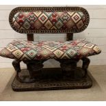 A South African carved bench seat with a kilim style, upholstered and carved birds to back and base