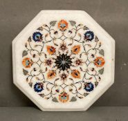 An octagonal inlaid marble chopping board or table top (31cm)