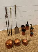 Brass fireside tools and a collection of copper measuring cups