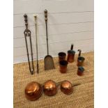 Brass fireside tools and a collection of copper measuring cups