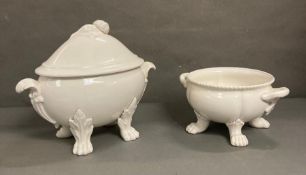 A large white soup bowl and tureen on lion paw feet