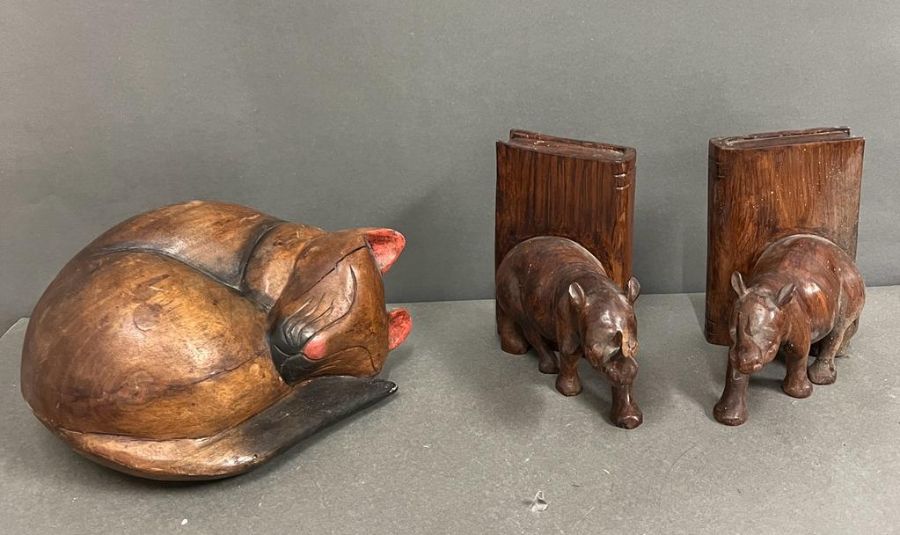A carved wooden bookends and a carved wooden cat