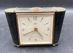 A Smiths Empire bedside clock with an enamel for the R.M.S Queen Mary Ocean Liner to top