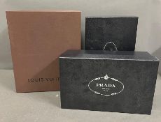 Three storage boxes/shoe boxes, Prada and Louis Vuitton