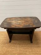 A metamorphic side table, opening up as a large table (H64cm W111cm D64cm folded)