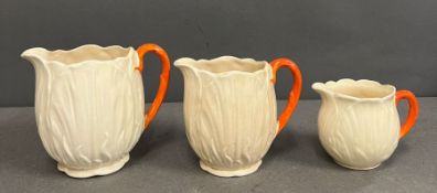 A set of three graduated lettuce ware jugs.