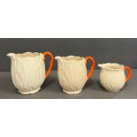 A set of three graduated lettuce ware jugs.