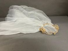 A vintage bridal veil with pearl head dress