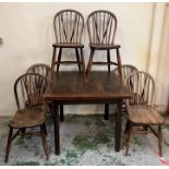Six hoop back spindle chairs with square pull out table