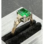 A 9ct gold and platinum set emerald style ring with diamond shoulders Size J