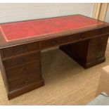 A large red leather topped pedestal directors desk (H78cm W180cm D90cm)