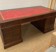 A large red leather topped pedestal directors desk (H78cm W180cm D90cm)