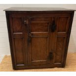 An English oak joined Charles I style provincial two door cabinet (H114cm W107cm D45cm)