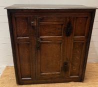 An English oak joined Charles I style provincial two door cabinet (H114cm W107cm D45cm)
